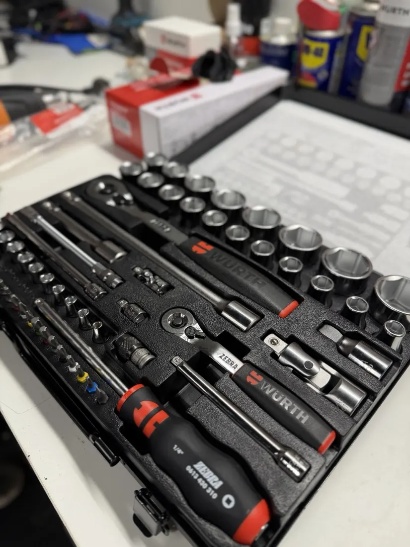 A professional ratchet and socket set in its case on the workbench