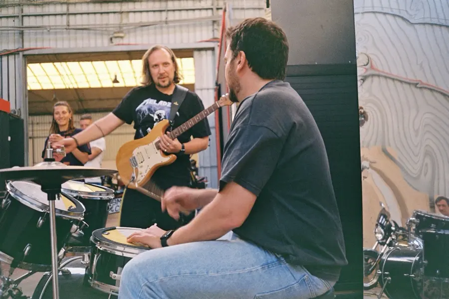 A guitarist and a drummer jamming in the garage