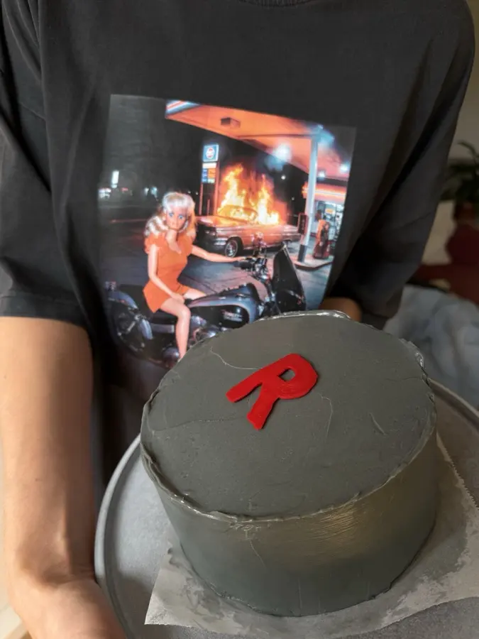 A grey cake with a red R on it, the morning after